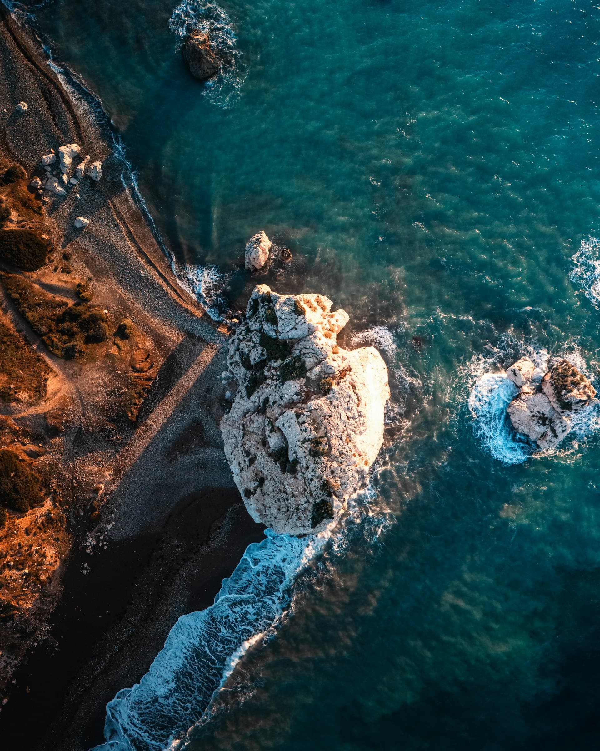 Aerial view of waves breaking on a rocky cove